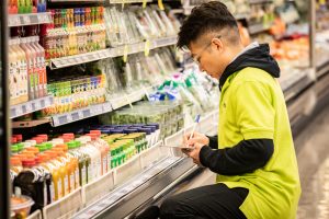 FreshCo employee stocks shelves ahead of grand opening of FreshCo Mission