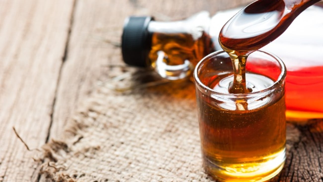 maple syrup in glass bottle on wooden table
