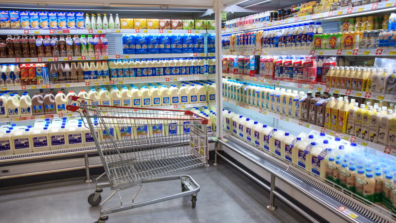Fresh Milk Bottles On Supermarket Stand.