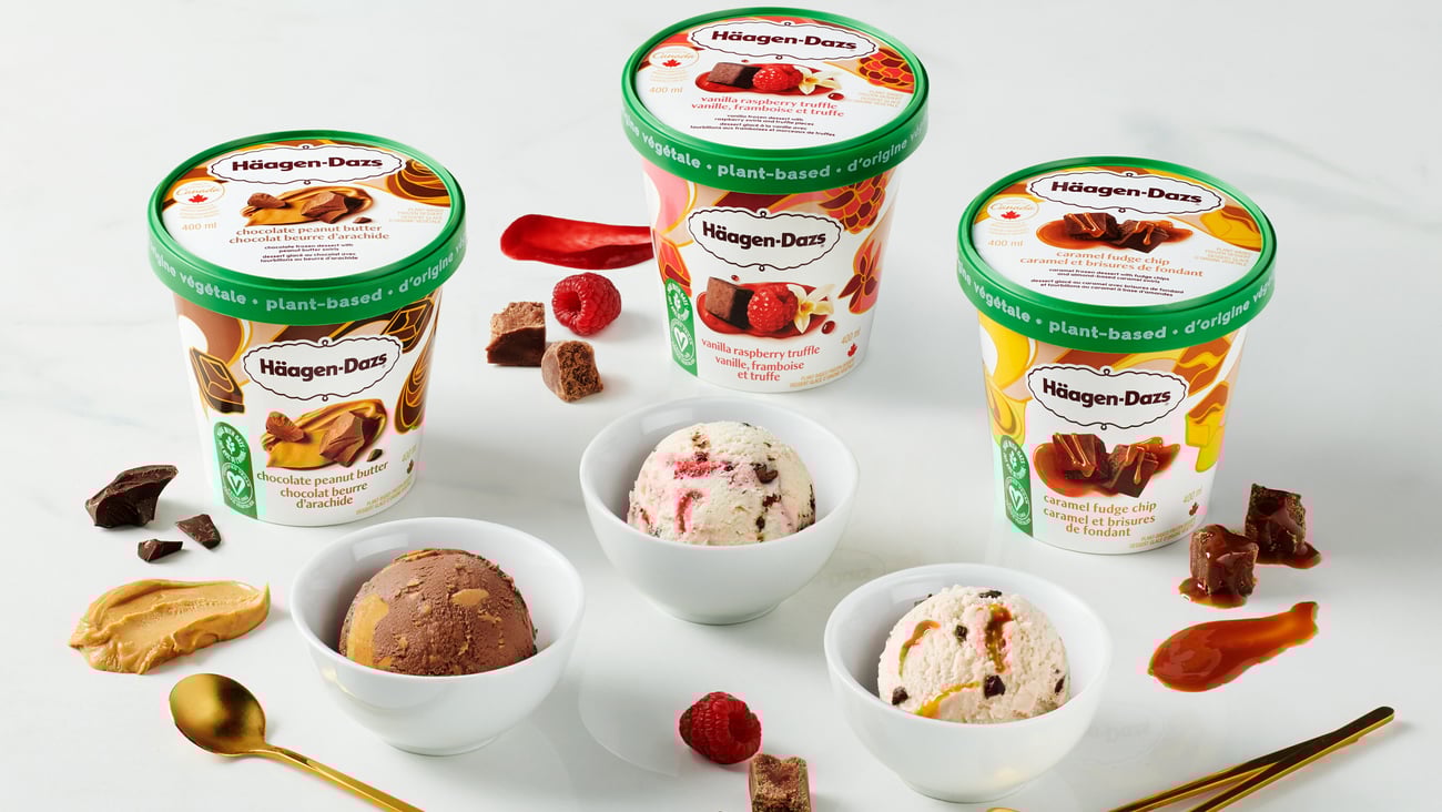 Tubs of Häagen-Dazs Plant-Based Collection sitting on a table with bowls filled with the frozen dessert