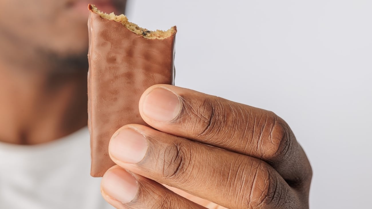 Man holding a bitten chocolate bar