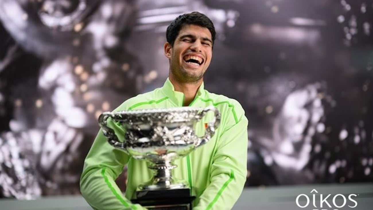 Carlos Alcaraz, posing with the Austrailian Open cup,  partners with Oikos Canada as brand ambassador. 