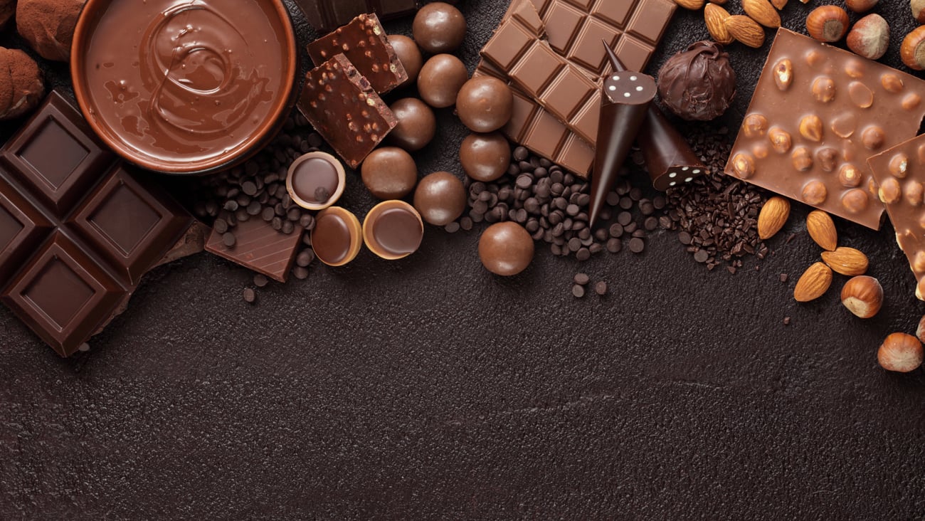 Chocolate candy box / Assortment of fine chocolates in white, dark, and milk chocolate and a bowl of melted chocolate