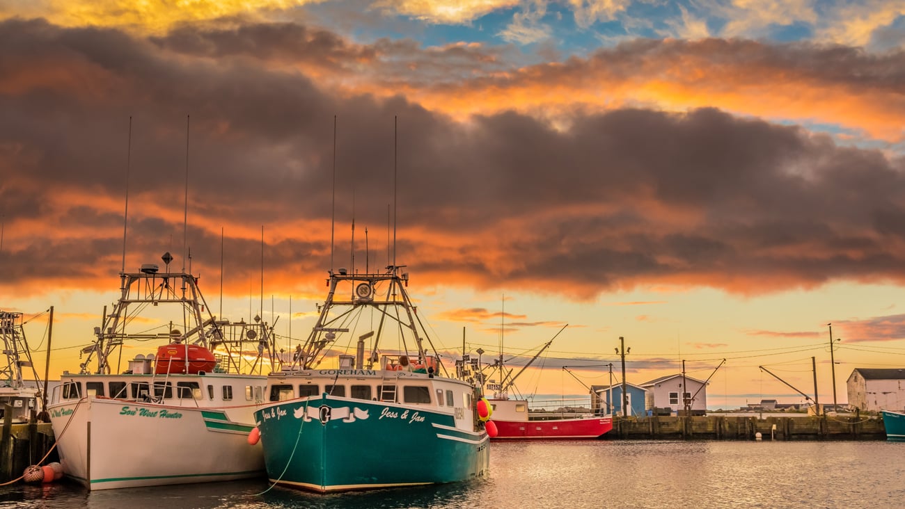 Lobster fishing boats arrive to home port wharf after a long day of pulling traps and gear.