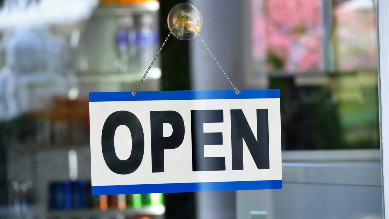Open sign hanging in the window of a store