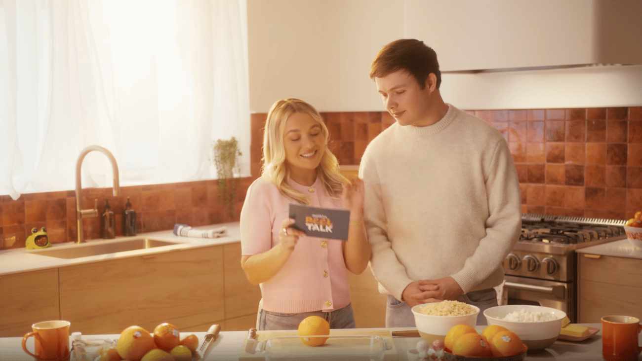 A boy and girl standing behind a kitchen counter