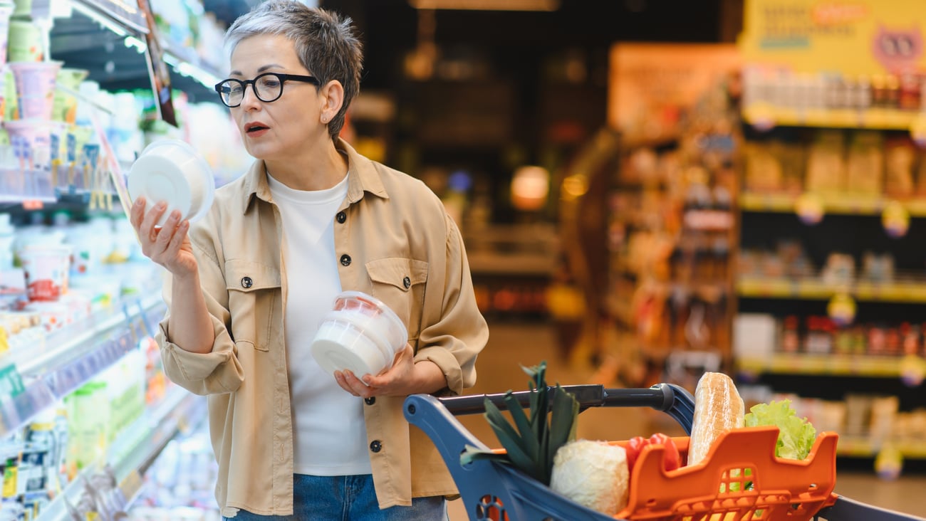 grocery shopper looking at product labels