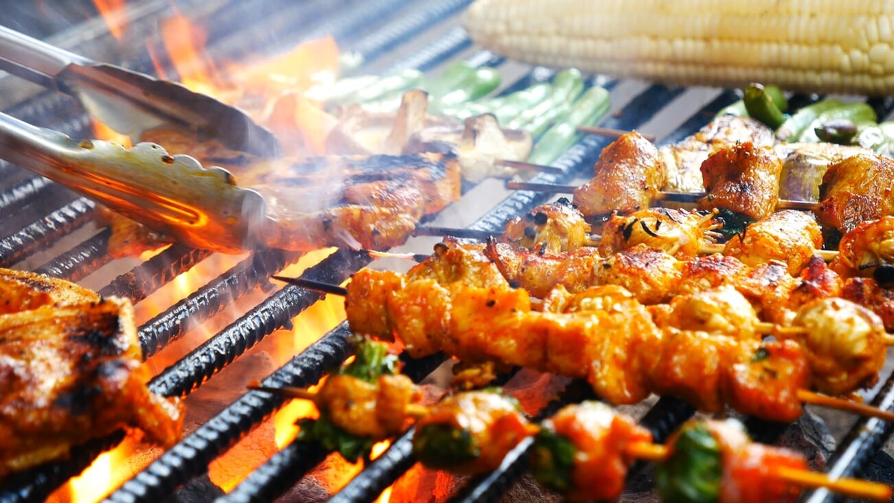 BBQ Barbecue grilled meat stick on fire flame with hot charcoal cooking outside. Beef grilling picnic outdoor with smoke bacon spicy sausage for party. Grill pork bbq on fire flame; Shutterstock ID 2418581423