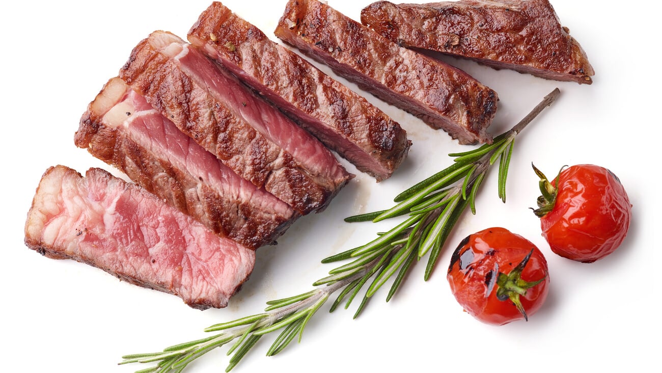 Grilled Sliced Beef Steak with tomatoes and rosemary Isolated on white background top view; Shutterstock ID 1572051148