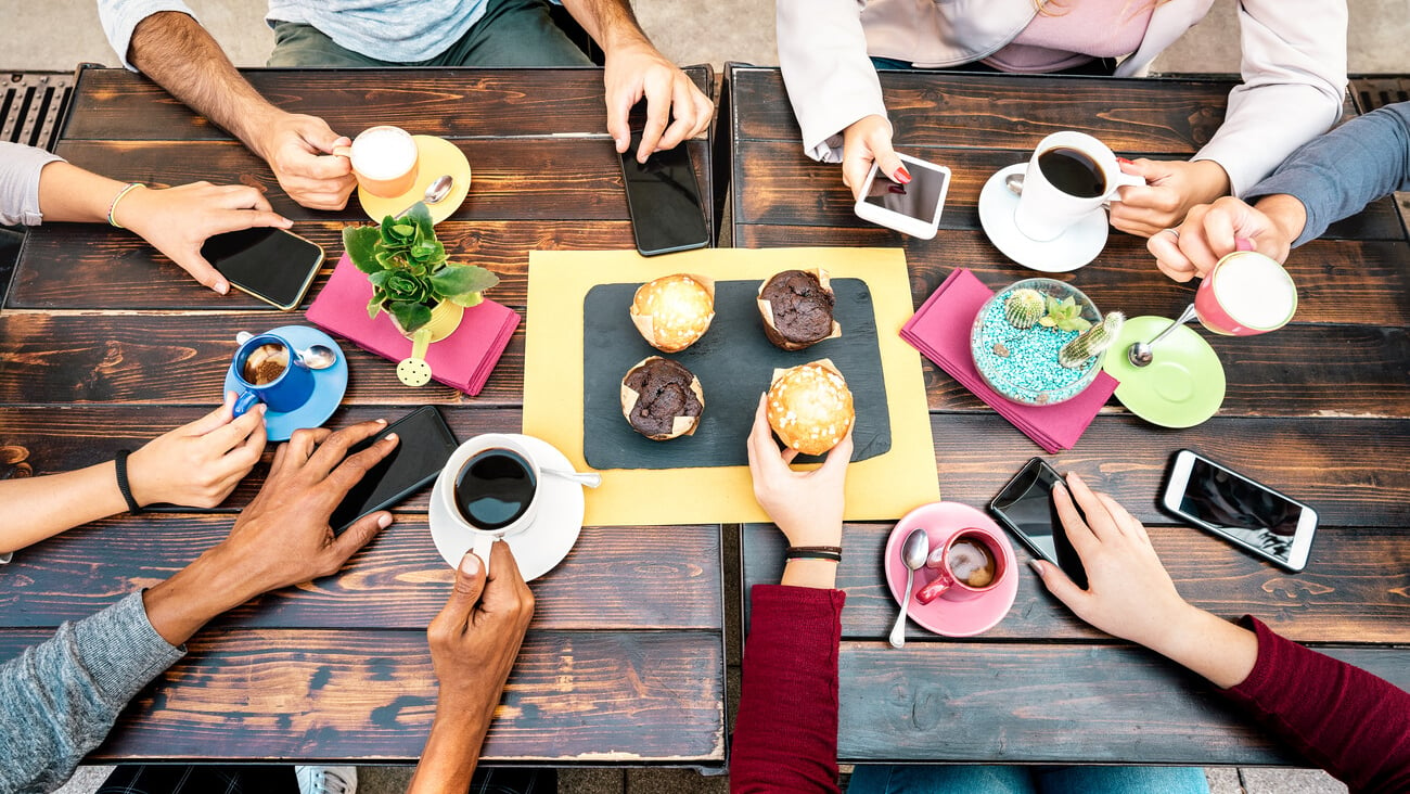 Top angle view of hands with phones at coffee shop restaurant - People having breakfast together with mobile smartphones at fashion cafe bar - Lifestyle concept on vivid filter; Shutterstock ID 1815257243