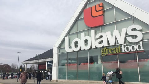 People line up in front of Loblaws grocery store during Ontario 3rd wave lockdown in Toronto, Canada