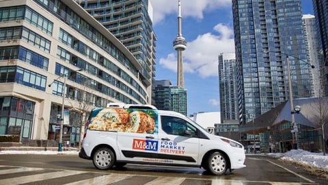 M&M delivery van against the Toronto cityscape 