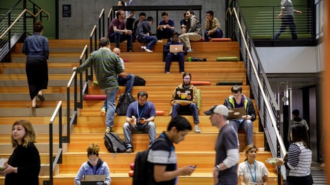 Amazon workers sitting on a set of stairs at the company's campus in Seattle