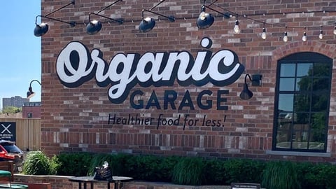 Exterior of Organic Garage, a brick building with outdoor lights and shrubs