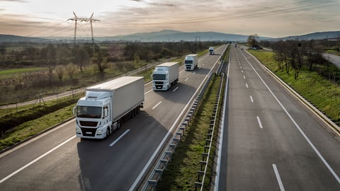 Caravan or convoy of trucks in line on a country highway