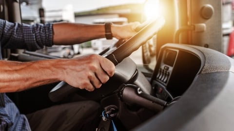Male truck driver at the wheel of a big rig