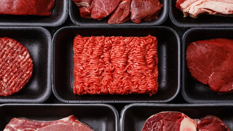 Different types of meat on black styrofoam trays