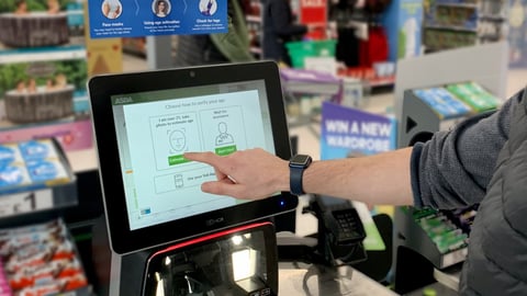 A man using the identification technology at an Asda self-checkout kiosk