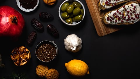 A spread of olives, roasted eggplant, and spices.