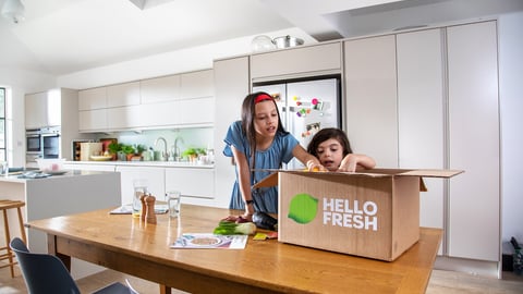 Two children unboxing a HelloFresh meal kit