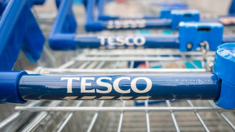  Tesco supermarket trolleys stacked in a line.