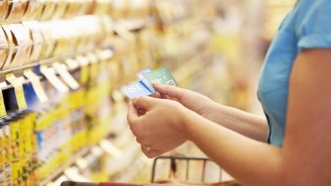 Grocery shopper holding coupons