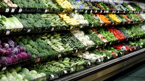 Fruits and vegitables displayed for sale in the produce department of a modern grocery store.