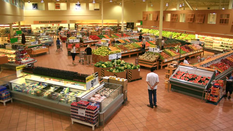 Store manager observing grocery store displays