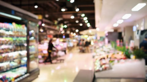 Abstract supermarket grocery store blurred defocused background with bokeh light