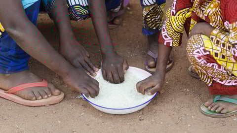 Close-Up Shot of Young African Boys and Girls Eating Outdoors