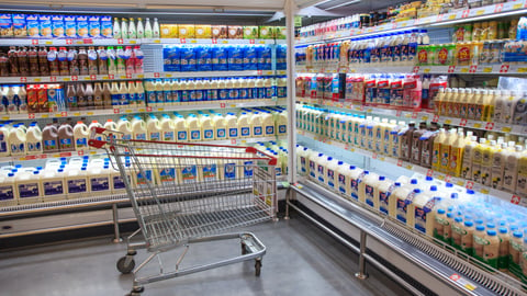 Fresh Milk Bottles On Supermarket Stand.