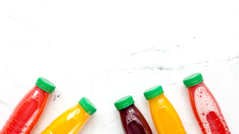 vegetable juice in plastic bottle on white table top view mock up