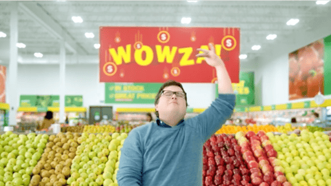 A man standing in the produce section of a Food Basics store shopping the Wowza sale