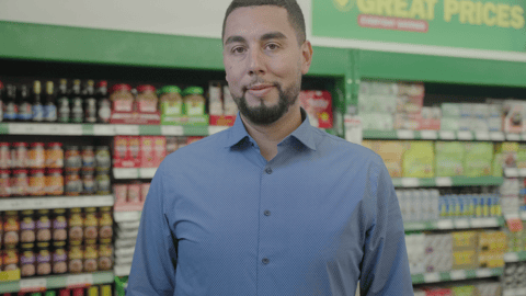 Mo Hamoud standing inside a Food Basics store