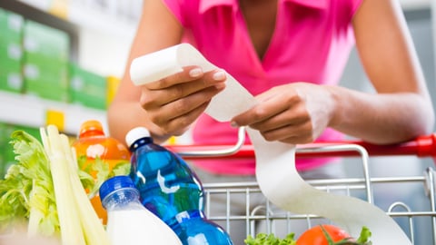 teaser woman checking grocery receipt food prices