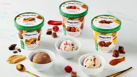 Tubs of Häagen-Dazs Plant-Based Collection sitting on a table with bowls filled with the frozen dessert