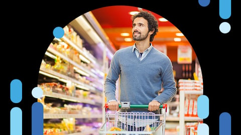 A man pushing a grocery cart through the store