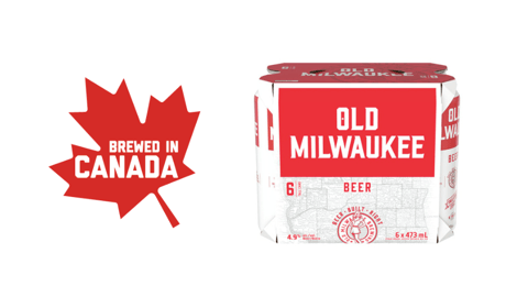 A case of Old Milwaukee beer next to a red maple leaf