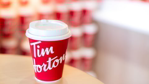 A Tim Hortons coffee cup sitting on a table