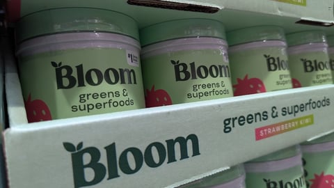 Bloom Nutrition greens and superfoods in strawberry kiwi on a shelf 