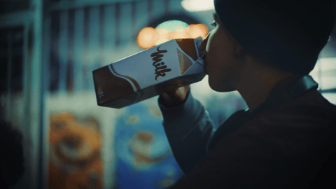 A man drinking milk from a carton