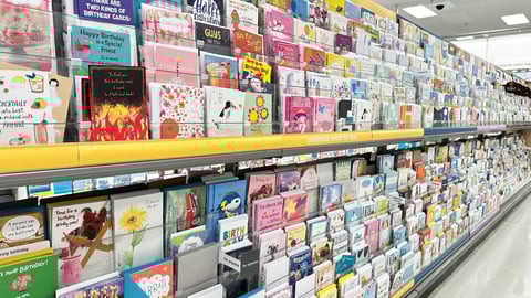 The shelves are filled with a wide variety of cards featuring colorful designs and messages for all ages and occasions at Target retail store.