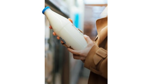 woman holding a bottle of milk