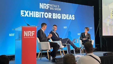 People sitting on a stage at NRF