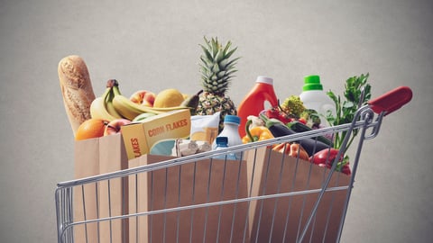 Shopping cart full of fresh groceries, grocery shopping concept