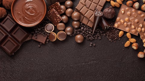 Chocolate candy box / Assortment of fine chocolates in white, dark, and milk chocolate and a bowl of melted chocolate