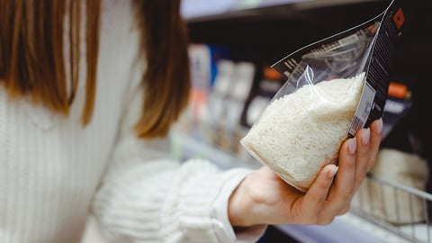 Shopper with a pack of rice in hand