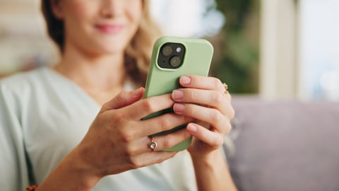 woman scrolling on phone watching videos