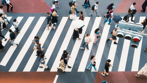people crossing a busy street