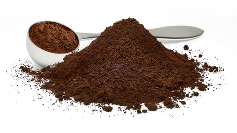 Ground coffee pile with metallic measuring scoop isolated on white background; Shutterstock ID 1386556535